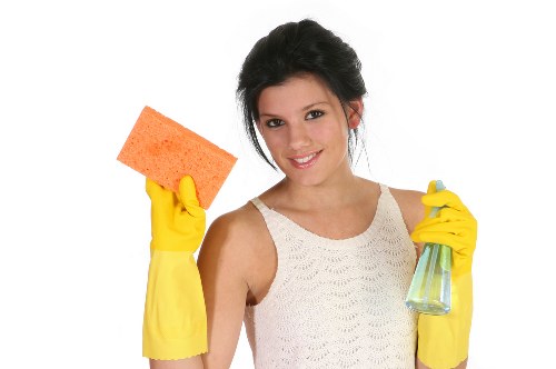 Cleaner preparing a safe work area with protective gear