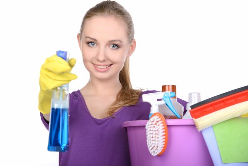 Local cleaner treating stains on a corner sofa in Swisscottage
